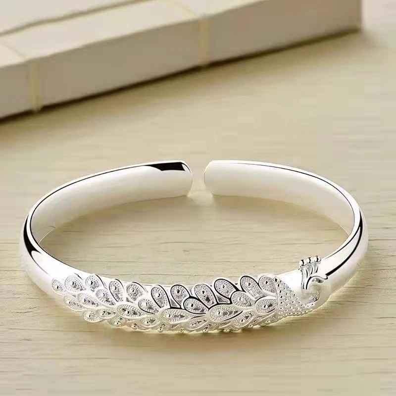 Elegancka bransoletka z filigranowym designem pióro pawia regulowana